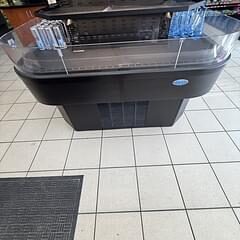 Open-top refrigerated display merchandiser island case on a store tile floor
