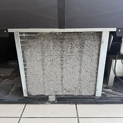 Dirty clogged evaporator coil filter pulled from a commercial refrigeration unit