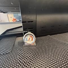 Refrigerator thermometer placed inside a commercial reach-in cooler shelf