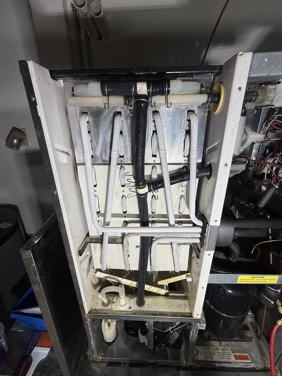Internal view of ice machine evaporator and drain pan — commercial ice machine repair, Armus Refrigeration (MA & RI)