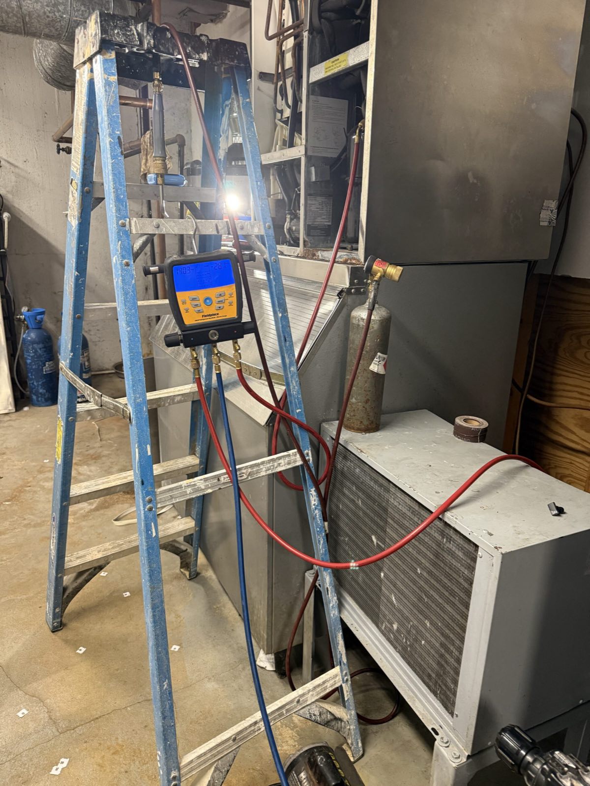 HVAC technician servicing commercial unit with gauges — commercial refrigeration service, Armus Refrigeration (MA & RI)